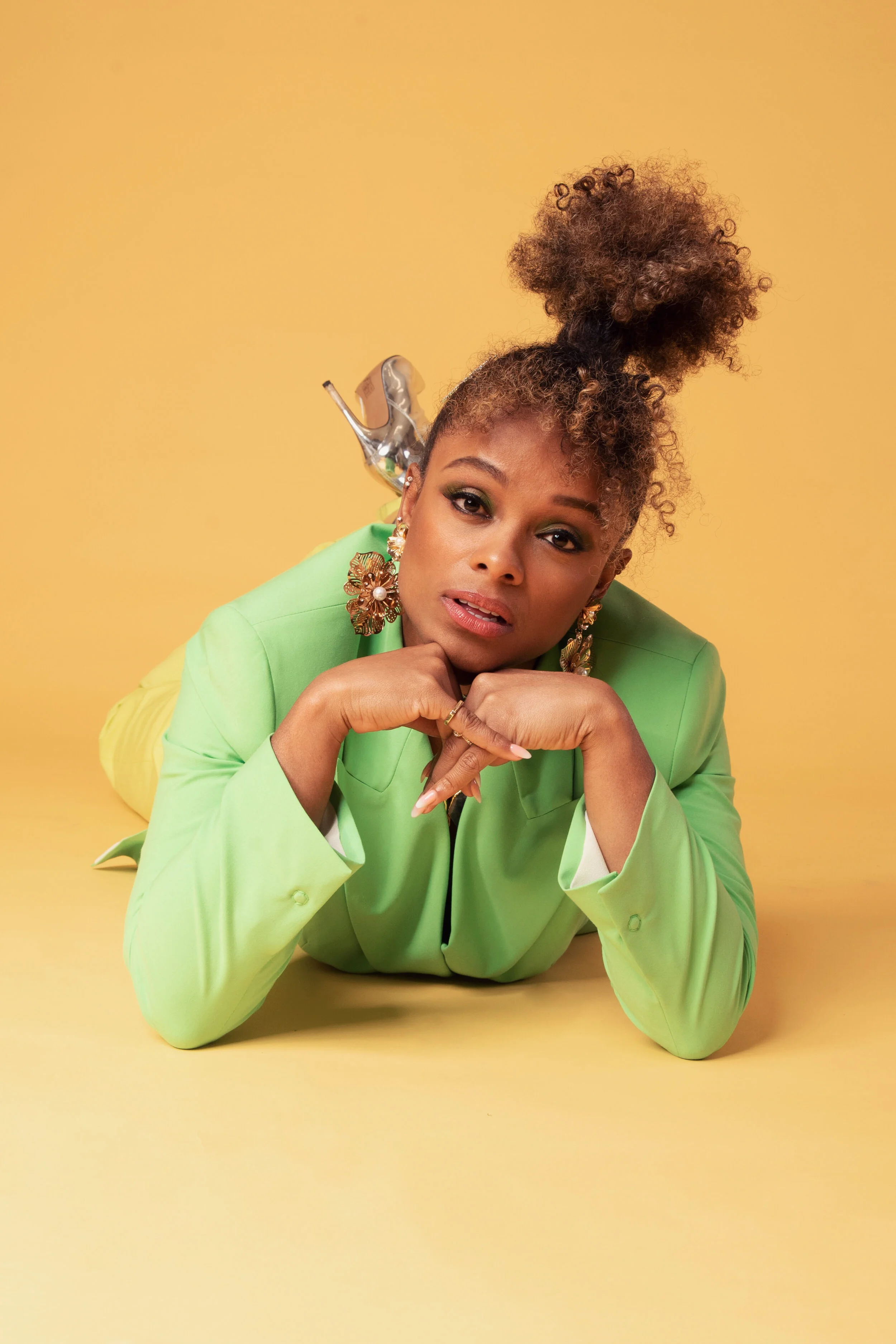 Fleur East for Darkus Magazine — Green suit, lying to camera