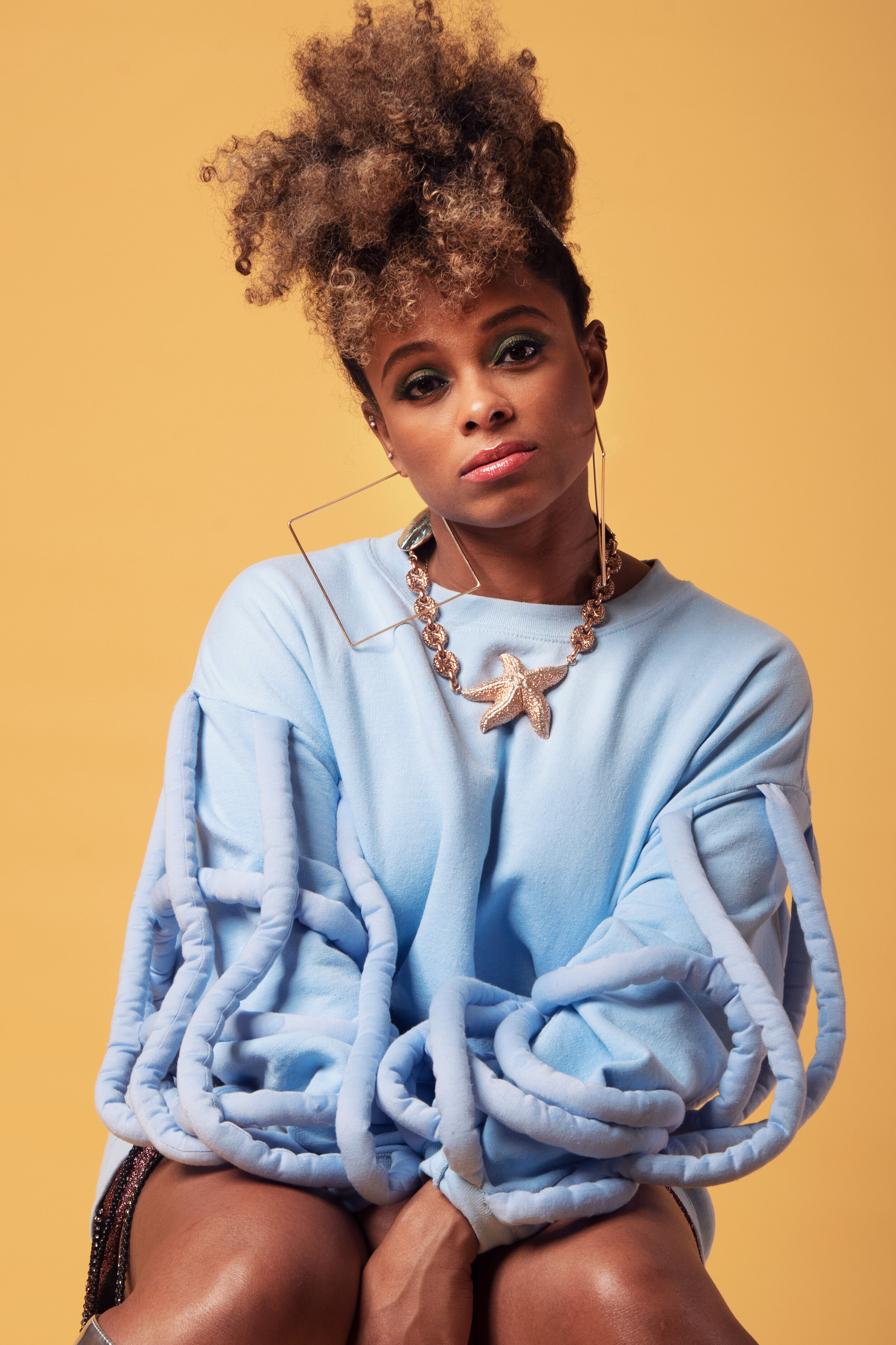 Fleur East for Darkus Magazine — Blue faux fur on ochre