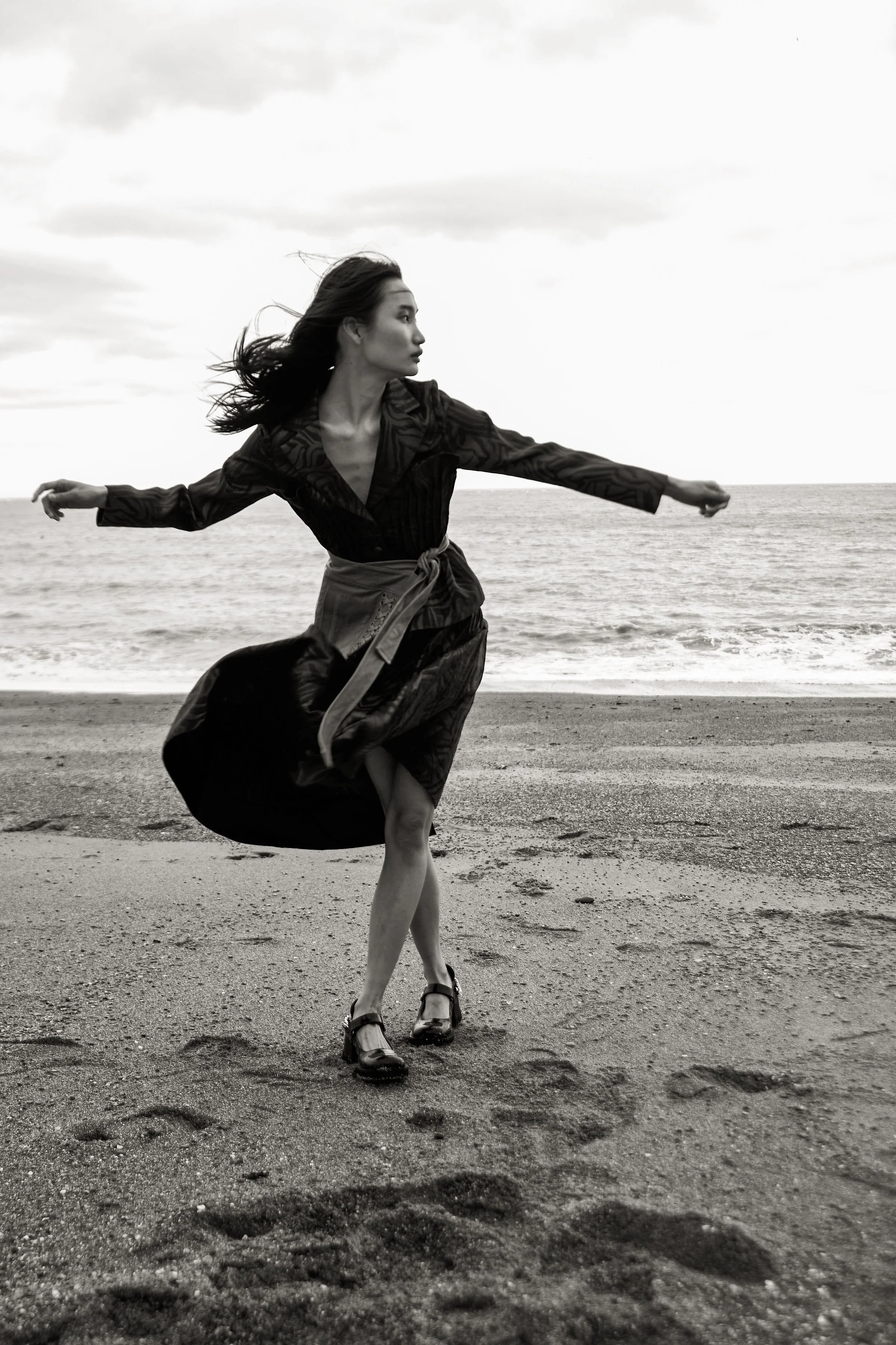 River Nile for Overdue Magazine — Black and white — arms open, dress in motion