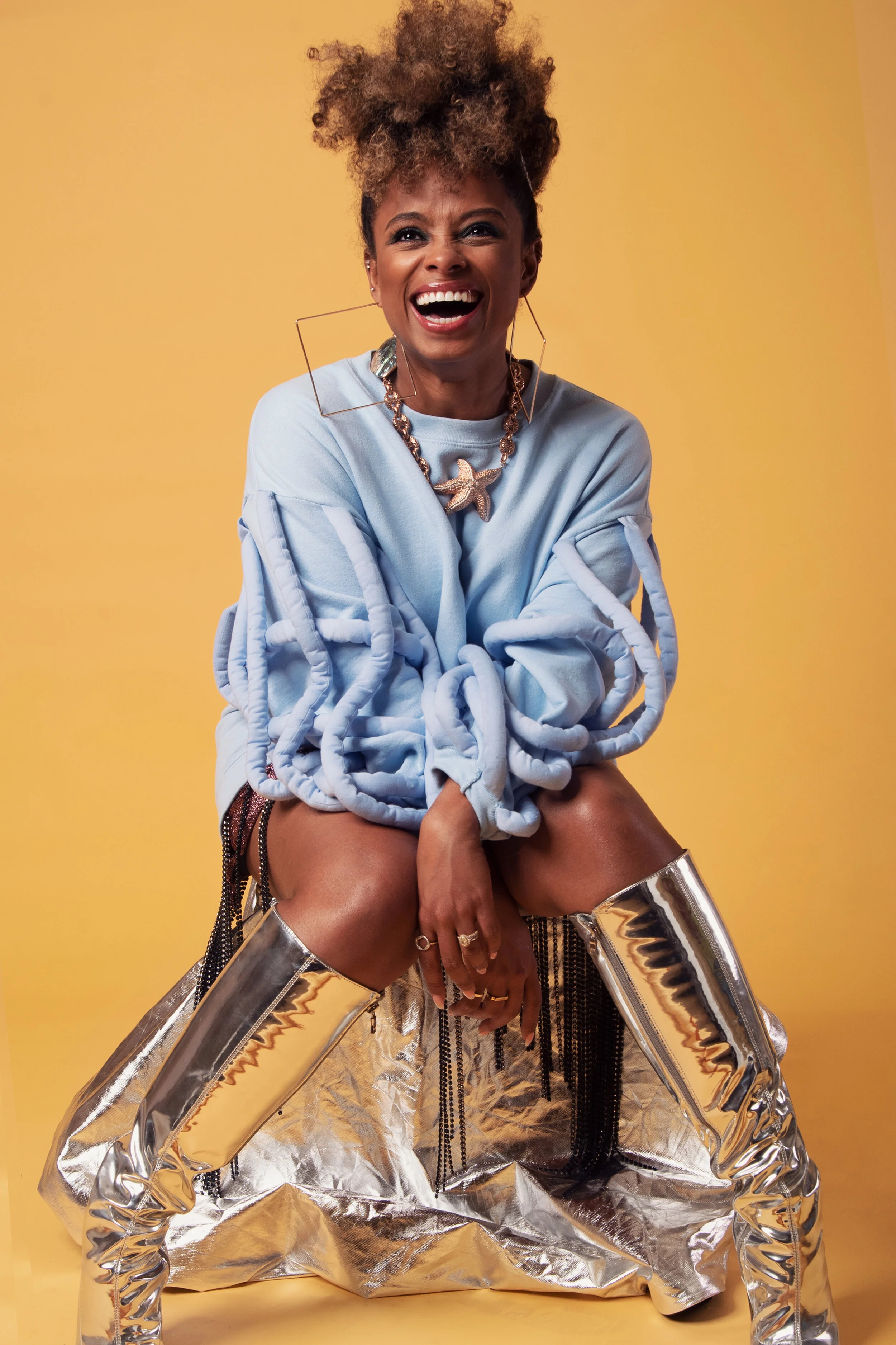 Fleur East for Darkus Magazine — Crouched, silver boots