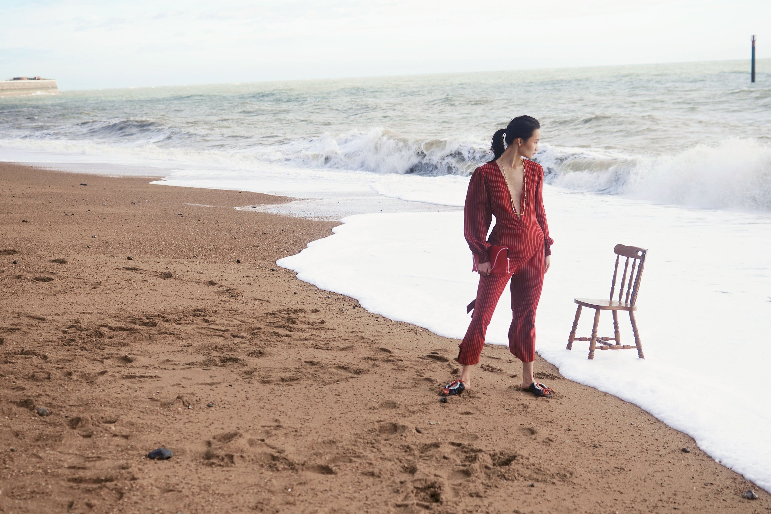 River Nile for Overdue Magazine — Red suit and the lone chair at the shoreline