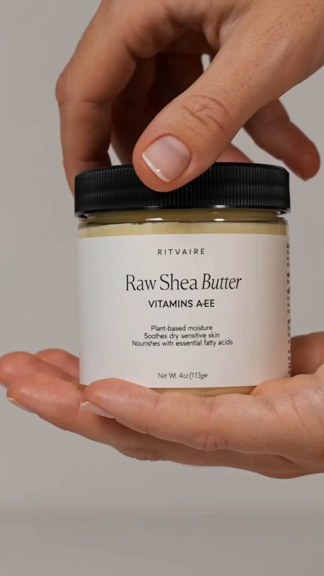 Rituaire raw shea butter jar held in hand